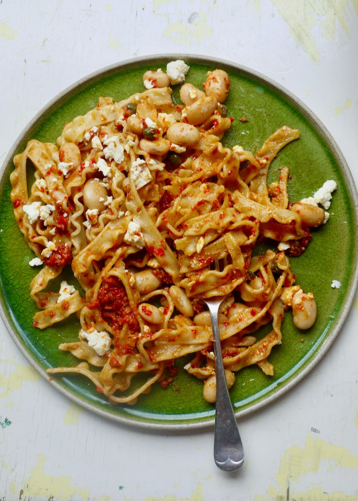 A green plate of pasta.