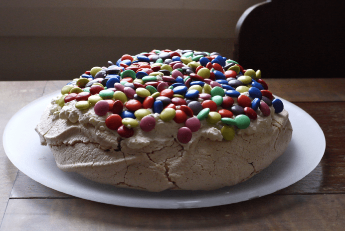 A pavlova covered in smarties.